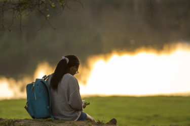 Student studying at Lake Lag