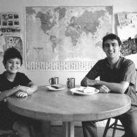 Ross Venook and his son sitting at a table with food