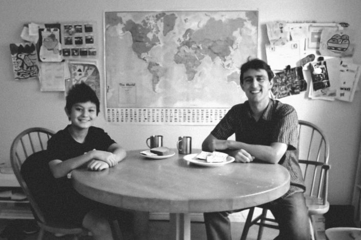 Ross Venook and his son sitting at a table with food