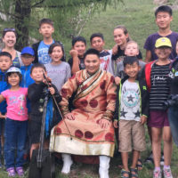 A group of people, mostly children, posing for a photo