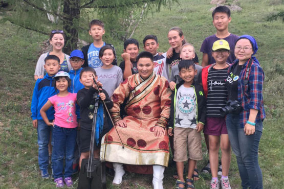 A group of people, mostly children, posing for a photo