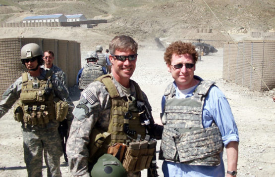 Joseph Felter and Eli Berman standing with a soldier behind them.