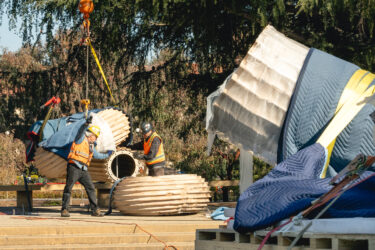 Art installers move sections of the sculpture into place