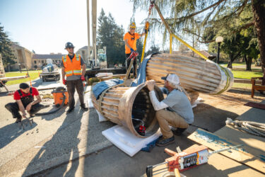 Installers work on one section of the sculpture