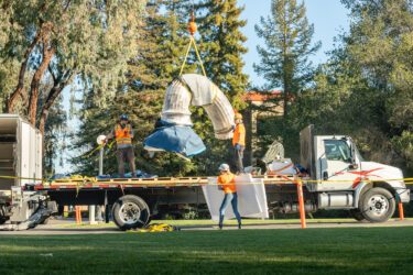 Art installers Jeff Schwartz, Teilor Goode and Esteban Granados with Agile Fine Arts move the last piece of Hello, by Xu Zhen, off the flat bed truck.